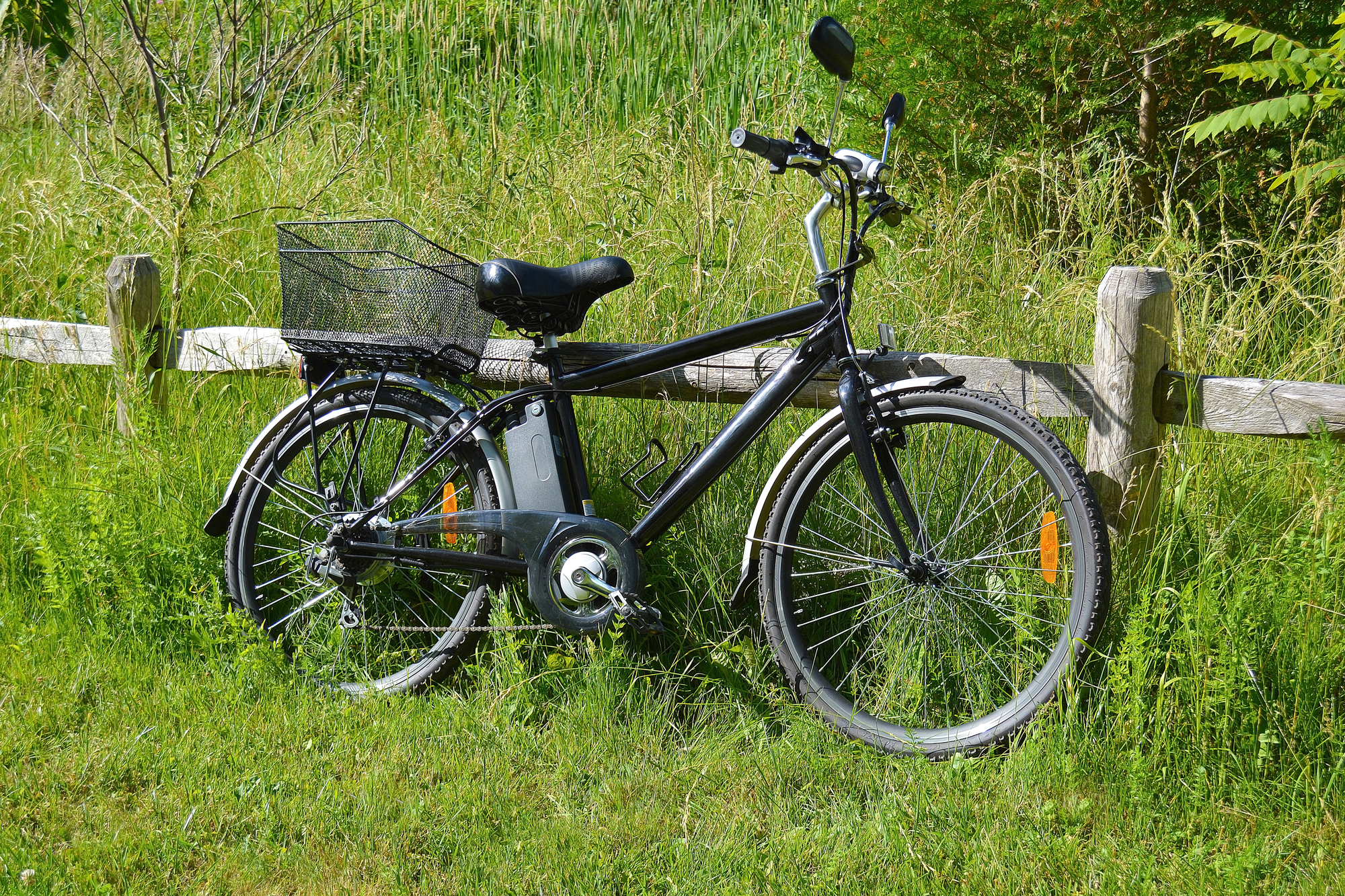 A typical Ebike leaning against a fence